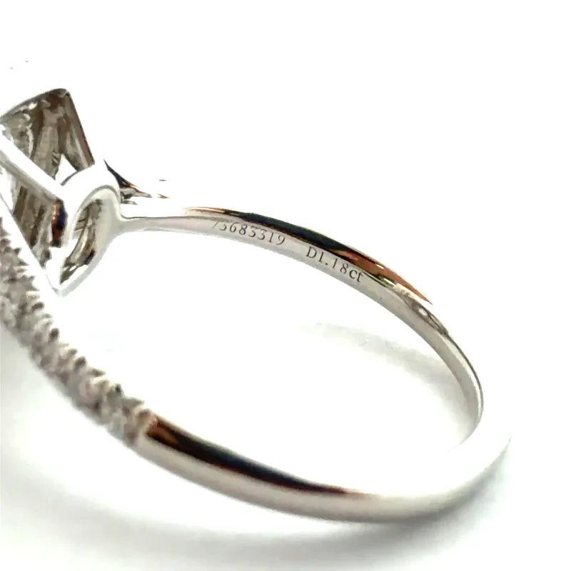 Close-up photo of a Tiffany ring band showing the stamped serial number and carat weight